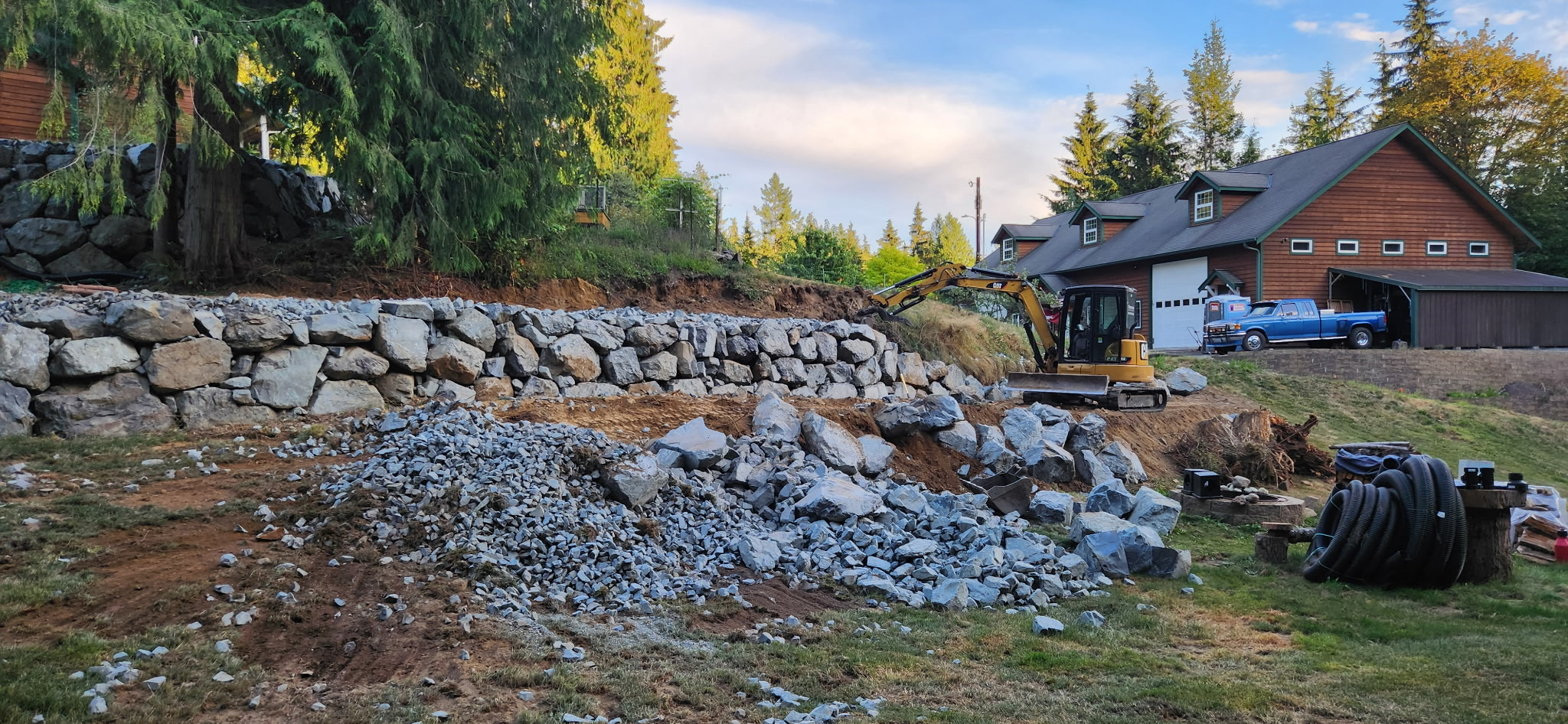 Before photo showing retaining wall installation in progress